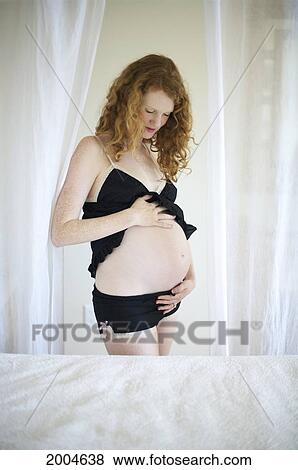 Hawaii, Kauai, Princeville, A Mother To Be Holds Her Belly, Awaiting Delivery. View Large Photo Image Stock Photo - Hawaii, Kauai, Princeville, A Mother To Be Holds Her Belly, Awaiting Delivery.. Fotosearch