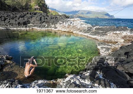 Hawaii, Kauai, Princeville, Queens Bath, Woman Sitting On Water's Edge Wearing Snorkel Gear. View Large Photo Image Stock Photo - Hawaii, Kauai, Princeville, Queens Bath, Woman Sitting On Water's Edge Wearing Snorkel Gear.. Fotosearch