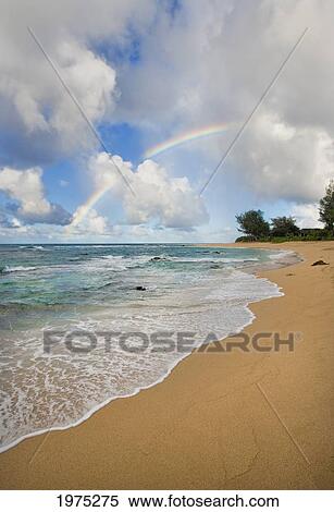 Stock Photography - Hawaii, Kauai, Rainbow On North Shore Beach.. Fotosearch