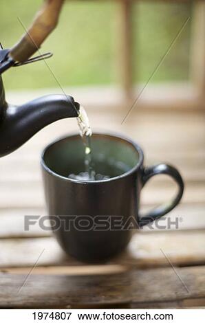Stock Photo - Hawaii, Kauai, Traditional Tea Setting, Hot Water Being Poured Into Cup.. Fotosearch