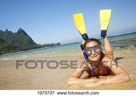 Stock Photo - Hawaii, Kauai, Tunnels Beach, A Woman Wearing Yellow And Blue Fins And Snorkeling Gear On Beach.. Fotosearch