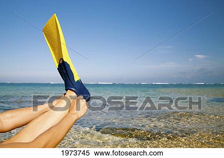 Hawaii, Kauai, Tunnels Beach, A Woman Wearing Yellow And Blue Fins On Beach. View Large Photo Image Stock Photography - Hawaii, Kauai, Tunnels Beach, A Woman Wearing Yellow And Blue Fins On Beach.. Fotosearch