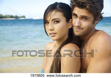 Stock Photography - Hawaii, Kauai, Tunnels Beach, Beautiful Couple On The Beach.. Fotosearch