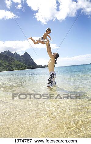 Hawaii, Kauai, Tunnels Beach, Dad With His Son Play Togteher. View Large Photo Image Stock Photo - Hawaii, Kauai, Tunnels Beach, Dad With His Son Play Togteher.. Fotosearch