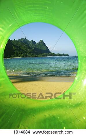 Picture - Hawaii, Kauai, Tunnels Beach, Green Innertube Framing Bali Hai Point.. Fotosearch