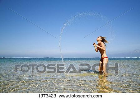 Hawaii, Kauai, Tunnels Beach, Attractive Woman In The Water Whipping Her Hair Around. View Large Photo Image Stock Image - Hawaii, Kauai, Tunnels Beach, Attractive Woman In The Water Whipping Her Hair Around.. Fotosearch