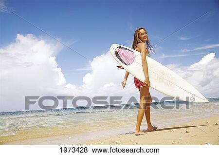 Stock Photo - Hawaii, Kauai, Tunnels Beach, Surfer Girl Enjoying A Day Out.. Fotosearch