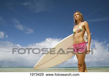 Stock Photo - Hawaii, Kauai, Tunnels Beach, Surfer Girl Enjoying A Day Out.. Fotosearch