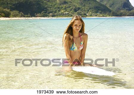 Stock Photo - Hawaii, Kauai, Tunnels Beach, Surfer Girl Enjoying A Day Out.. Fotosearch
