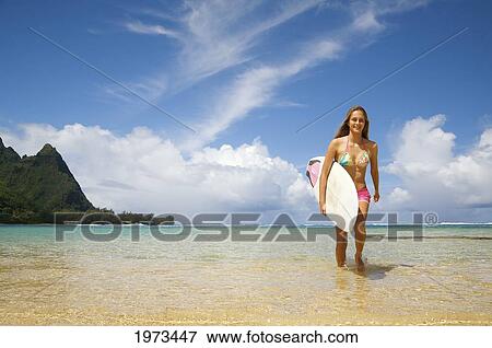 Stock Photo - Hawaii, Kauai, Tunnels Beach, Surfer Girl Enjoying A Day Out.. Fotosearch