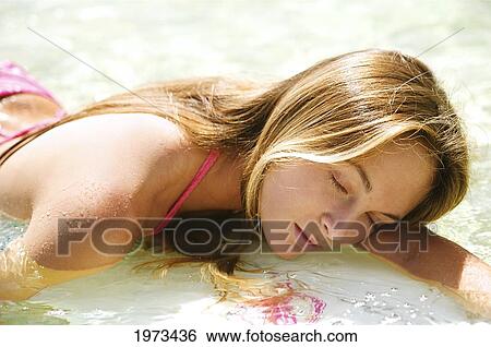 Stock Photograph - Hawaii, Kauai, Tunnels Beach, Surfer Girl Enjoying A Day Out.. Fotosearch