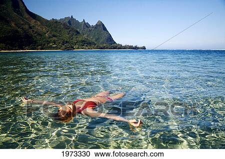 Hawaii, Kauai, Tunnel's Beach, Woman Floats In The Ocean. View Large Photo Image Stock Image - Hawaii, Kauai, Tunnel's Beach, Woman Floats In The Ocean.. Fotosearch
