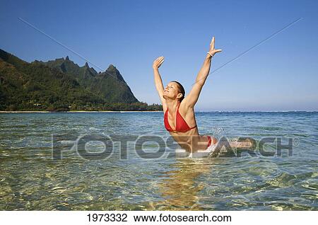 Hawaii, Kauai, Tunnel's Beach, Woman Leaps Into The Ocean. View Large Photo Image Stock Image - Hawaii, Kauai, Tunnel's Beach, Woman Leaps Into The Ocean.. Fotosearch