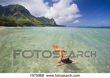 Hawaii, Kauai, Tunnels Beach, Woman Floating In The Ocean. View Large Photo Image Stock Photo - Hawaii, Kauai, Tunnels Beach, Woman Floating In The Ocean.. Fotosearch