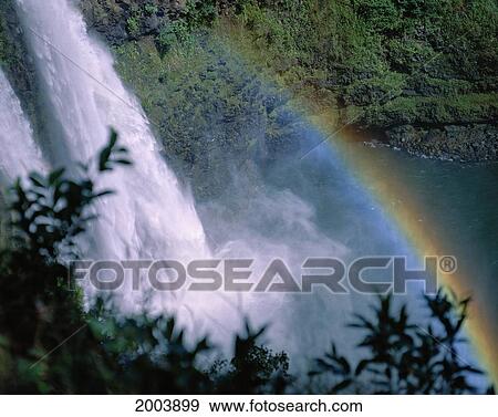 Stock Photo - Hawaii, Kauai, View Looking Down Wailua Falls With Rainbow Arching Across Into Water. Fotosearch