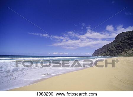 Stock Image - Hawaii, Kauai, View Of Beautiful Barking Sands Beach At Polihale State Park With The Cliffs Of The Na Pali Coast On A Clear Day.. Fotosearch