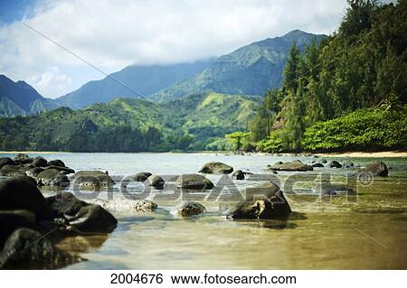 Hawaii, Kauai, Waikoko, Ocean Shoreline And Mountains In Distance. View Large Photo Image Stock Photograph - Hawaii, Kauai, Waikoko, Ocean Shoreline And Mountains In Distance.. Fotosearch