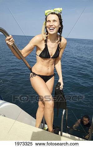 Stock Photography - Hawaii, Kauai, Woman Stands On A Dock And Poses For The Camera.. Fotosearch