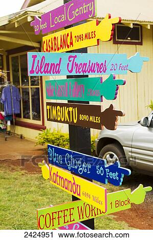 Stock Image - Hawaii, Lanai, Lanai City, Colorful sign shows distances to landmarks near and far.. Fotosearch