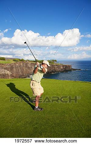 Stock Photo - Hawaii, Lanai, Man Hitting A Tee Shot On The Challenge At Manele Golf Course.. Fotosearch