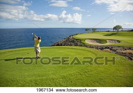 Picture - Hawaii, Lanai, Man Playing Golf At The Challenge At Manele Golf Course.. Fotosearch