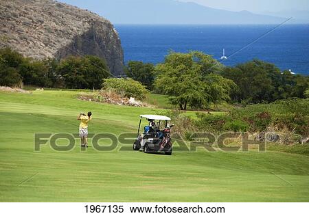 Stock Photography - Hawaii, Lanai, Man Playing Golf At The Challenge At Manele Golf Course.. Fotosearch