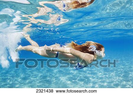 Stock Photo - Hawaii, Lanai, Manele Bay, Young Woman Swimming Near Ocean Surface.. Fotosearch