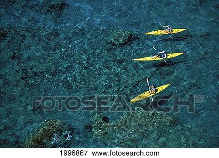 Stock Photo - Hawaii, Lanai, South Coast, Side Angled View From Above 3 Men Kayaking Over Coral Reef, All In Yellow Kayaks. Fotosearch