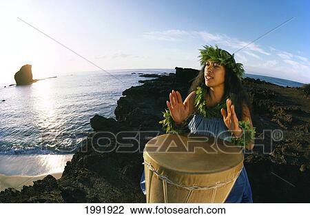 Hawaii, Lanai, Sweetheart Rock, Hula Dancer Chanting And Drumming At Sunrise View Large Photo Image Stock Image - Hawaii, Lanai, Sweetheart Rock, Hula Dancer Chanting And Drumming At Sunrise. Fotosearch