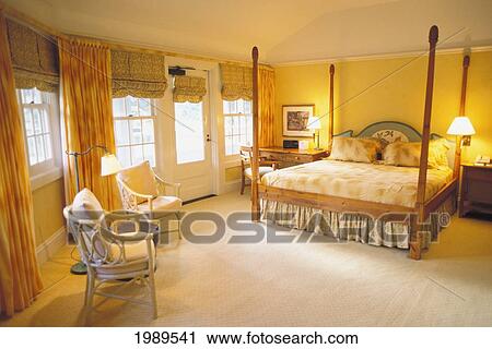 Stock Image - Hawaii, Lanai, The Lodge At Koele, Interior Of Suite With Golden Lighting, Windows Open. Fotosearch