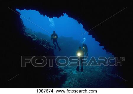 Picture - Hawaii, Lanai, Three Divers With Flashlights, Pictured At An Opening To First Cathedral.. Fotosearch