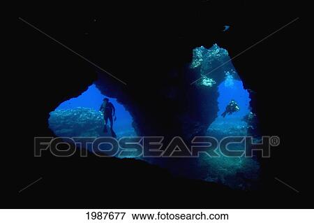 Stock Photo - Hawaii, Lanai, Two Divers With Flashlights, Pictured At The Entrance To Second Cathedral.. Fotosearch
