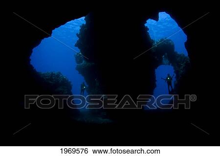 Stock Photograph - Hawaii, Lanai, Two Divers With Flashlights, Pictured At The Entrance To Second Cathedral.. Fotosearch
