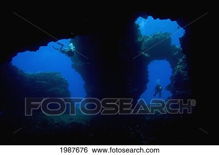 Stock Photograph - Hawaii, Lanai, Two Divers With Flashlights, Pictured At The Entrance To Second Cathedral.. Fotosearch