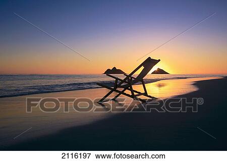 Stock Photo - Hawaii, Lanikai, Empty beach chair at sunset.. Fotosearch