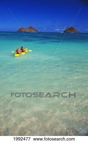 Hawaii, Lanikai, Two Women In Yellow Kayak, Turquoise Ocean, Head To Mokulua Islands. View Large Photo Image Stock Photo - Hawaii, Lanikai, Two Women In Yellow Kayak, Turquoise Ocean, Head To Mokulua Islands.. Fotosearch