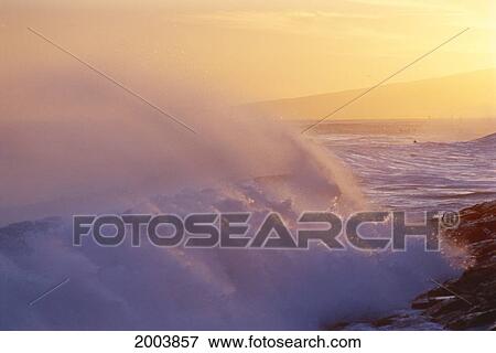 Stock Photo - Hawaii, Large Stormy Curling Wave At Sunset, Spray In Golden Sky. Fotosearch