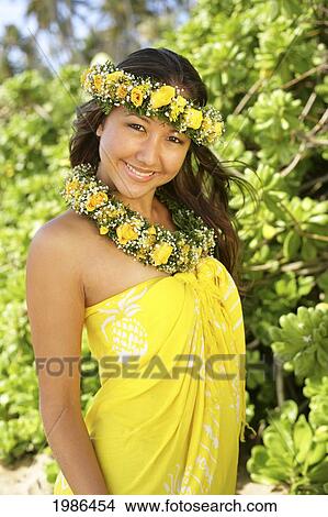 Picture - Hawaii, Local Girl Wearing Bright Yellow Pareo And Flower Leis.. Fotosearch