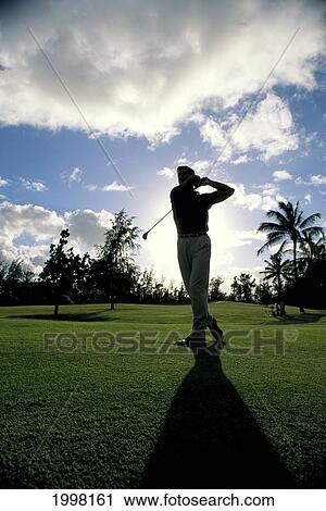 Stock Image - Hawaii, Man Silhouette Swings A Golf Club, Shadow. Fotosearch