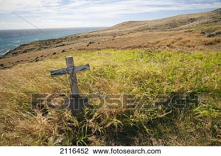 Stock Image - Hawaii, Maui, A lone cross in a field of grass.. Fotosearch