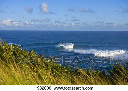 Stock Photo - Hawaii, Maui, A small, perfect peak at Peahi or Jaws, view from land. Fotosearch