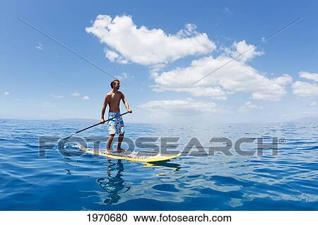 Stock Image - Hawaii, Maui, Athletic Young Man On A Stand Up Paddle Board. Fotosearch