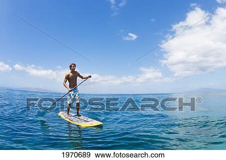 Stock Photo - Hawaii, Maui, Athletic Young Man On A Stand Up Paddle Board. Fotosearch