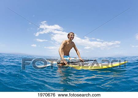 Stock Photograph - Hawaii, Maui, Athletic Young Man On A Stand Up Paddle Board. Fotosearch
