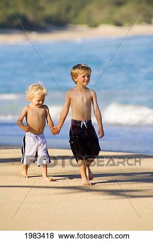 Stock Photo - Hawaii, Maui, Baldwin Beach, Adorable Little Boys Walking Along The Waters Edge.. Fotosearch