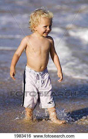 Stock Photograph - Hawaii, Maui, Baldwin Beach, Adorable Little Boy Playing At The Waters Edge.. Fotosearch