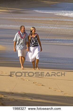Hawaii, Maui, Baldwin Beach, Couple On Vacation Walking Down The Beach Holding Hands View Large Photo Image Stock Photo - Hawaii, Maui, Baldwin Beach, Couple On Vacation Walking Down The Beach Holding Hands. Fotosearch