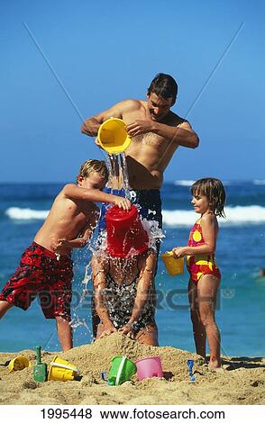 Stock Photo - Hawaii, Maui, Baldwin Beach, Family On Vacation, Mom And Kids Pour Water On Mom.. Fotosearch