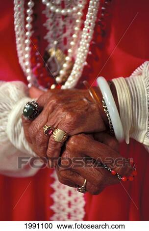 Stock Image - Hawaii, Maui, Close-Up Of Senior Local Woman Hands And Jewelry, Rings Bracelets Necklaces. Fotosearch