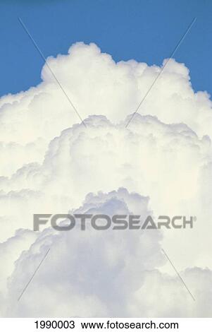 Stock Image - Hawaii, Maui, Cumulus Clouds Three Puffs Atop Each Other. Fotosearch